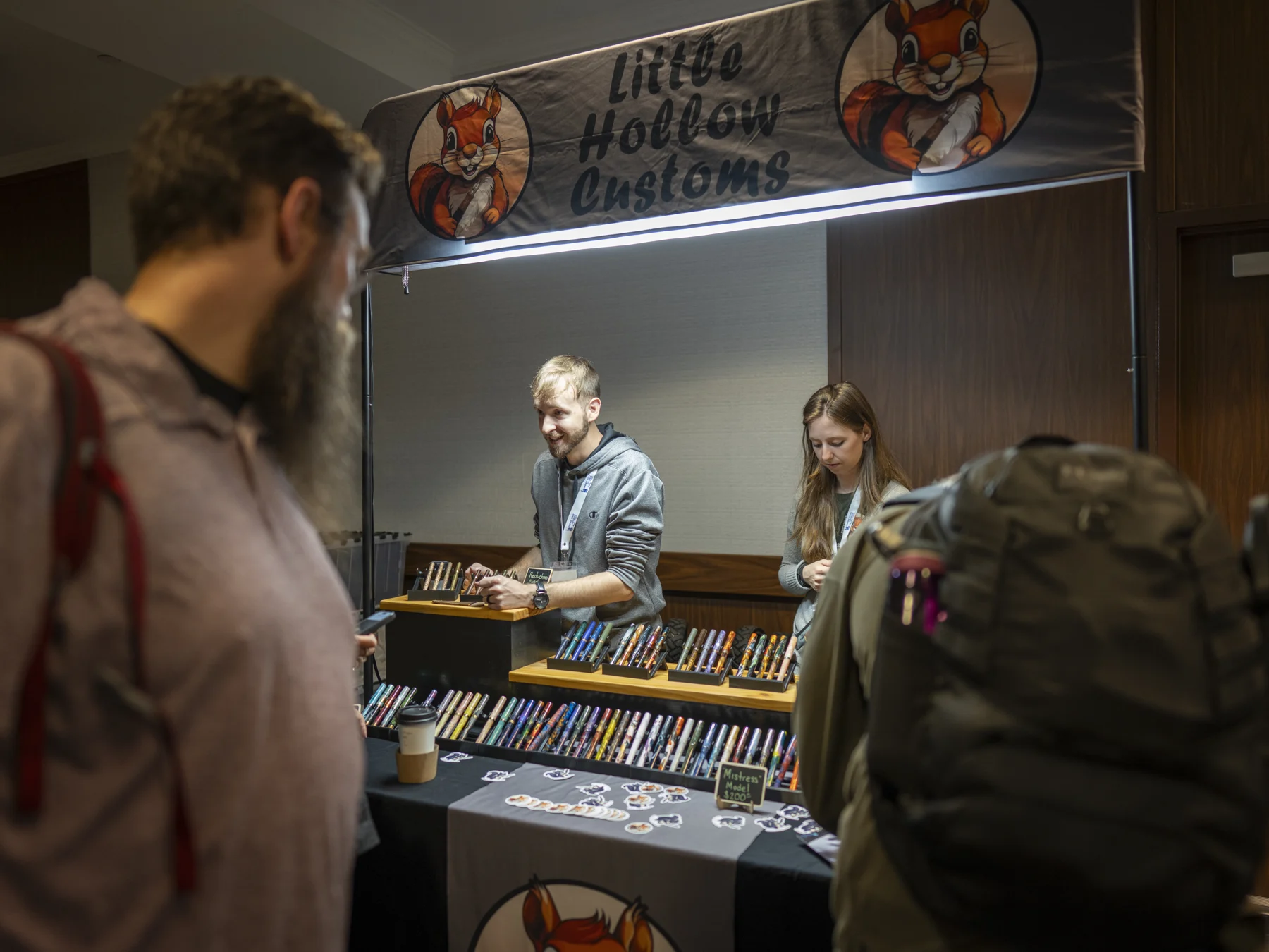 Visitors browsing colorful pens at Little Hollow Customs
